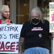 Healthcare and LGBTQ rights activists hold signs as they stage a protest outside of the San Francisco Federal Building on August 08, 2022, in San Francisco, California.